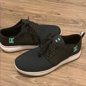 Men’s black and green Under Armour tennis shoes